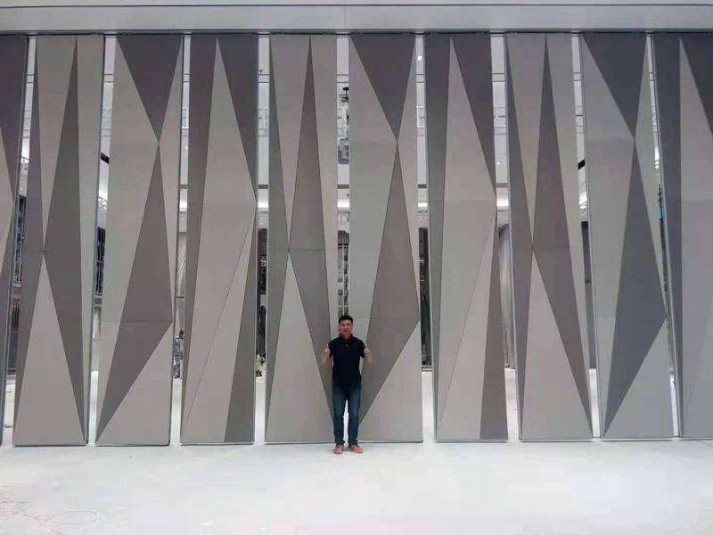 Foldable partition wall Malaysia project with geometric design finish, demonstrating smooth roller system and stacking. Foldable partition wall Malaysia project with geometric design finish, demonstrating smooth roller system and stacking.