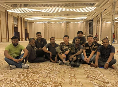 Installation team and clients celebrating successful completion of banquet hall partition project Installation team and clients celebrating successful completion of banquet hall partition project